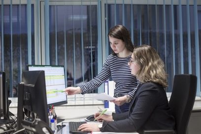 Zwei Frauen überprüfen am Computer gemeinsam Daten, die für die Abrechnung des Lohns wichtig sind.